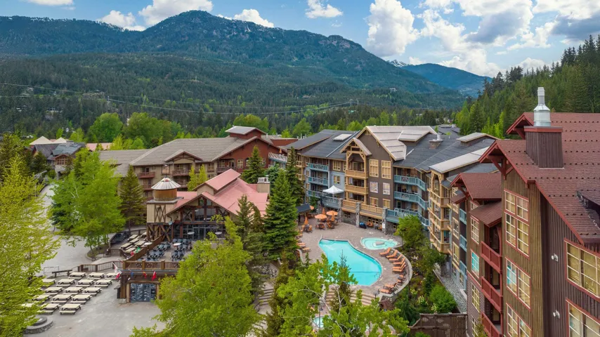 Drone / aerial view of mountains and a pool