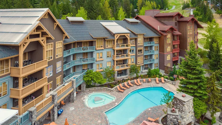 Community pool with a hot tub and a patio area