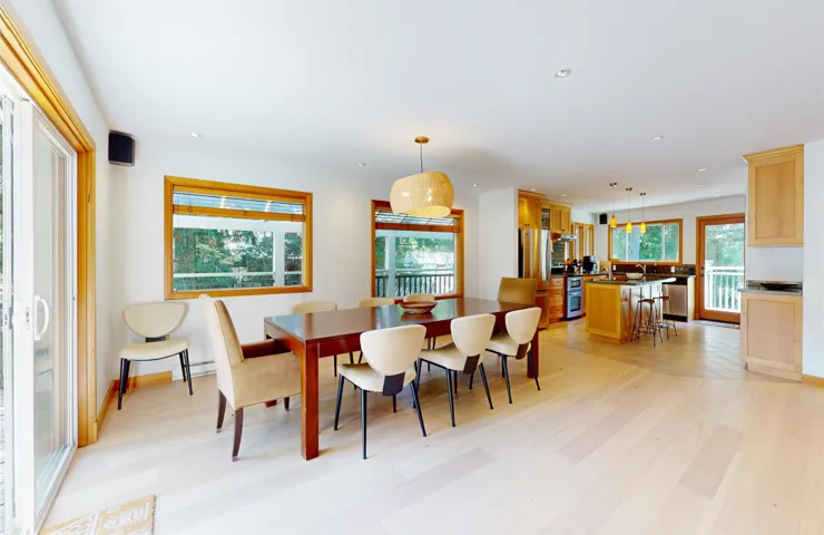 Open-concept living space featuring wood-finish flooring and ample natural light