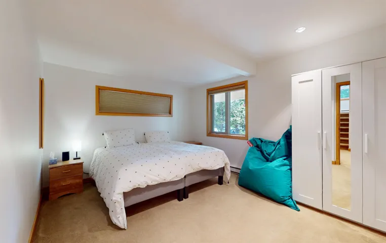 Bedroom featuring neutral wall paint, light brown carpet flooring, and recessed ceiling lighting