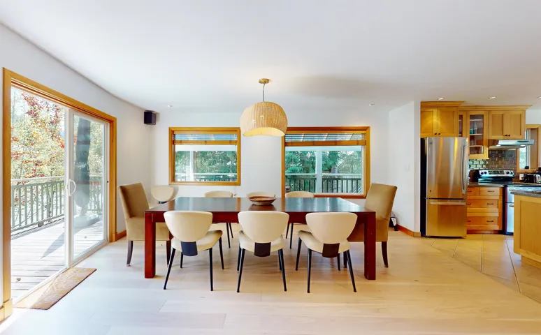 Dining area featuring wood-finish flooring and a contemporary light fixture