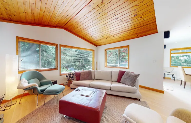 Vaulted wood-paneled ceiling accentuates the living space
