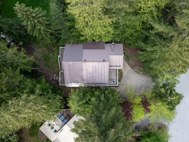 Contemporary residence featuring a metal roof and multiple levels