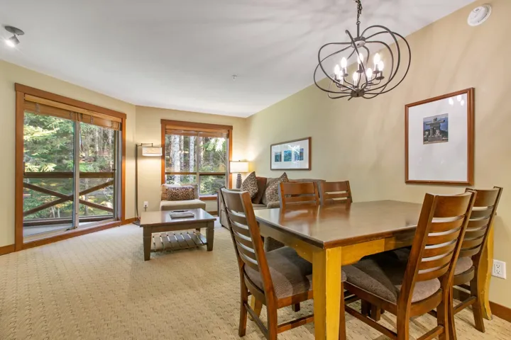 Dining space featuring baseboards and a chandelier