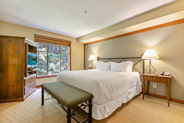 Bedroom featuring baseboards and light carpet