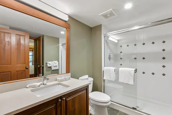 Bathroom featuring a stall shower, vanity, and recessed lighting