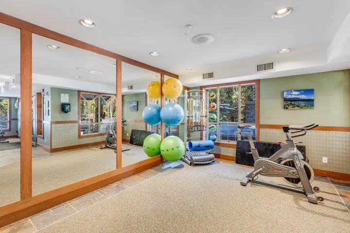 Exercise area with wainscoting, recessed lighting, and carpet floors