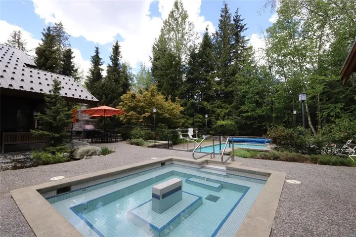 View of pool featuring an in-ground hot tub and a patio area
