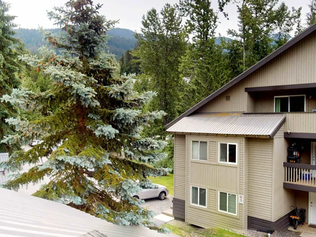 View of side of property featuring a mountain view and a metal roof
