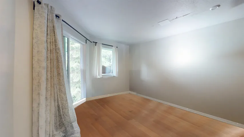 Empty room with wood finished floors and baseboards