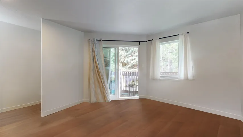 Spare room with wood finished floors and baseboards