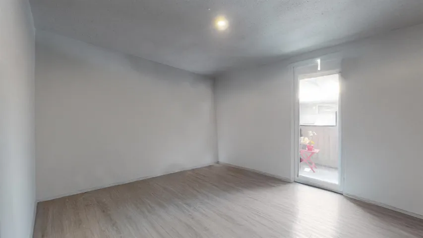 Spare room featuring wood finished floors