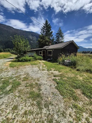 View of front of home with a mountain view, board and batten siding, and a chimney