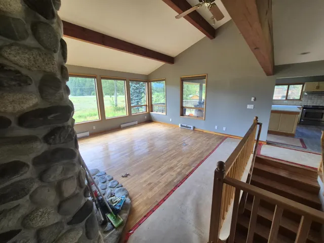 Living area featuring ceiling fan and a baseboard radiator