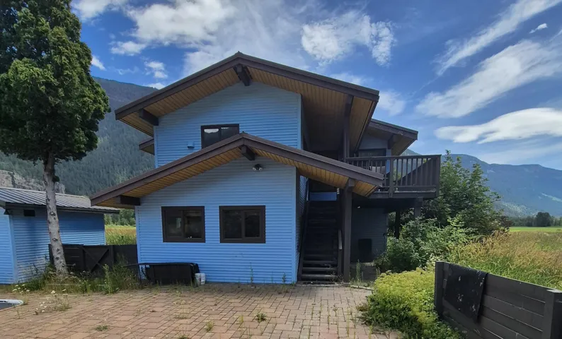 Rear view of house with a mountain view and a patio