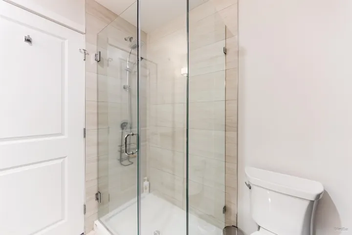 Full bath with toilet and a stall shower