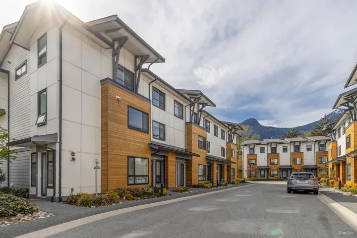 View of asphalt street featuring a mountain view, a residential view, and curbs