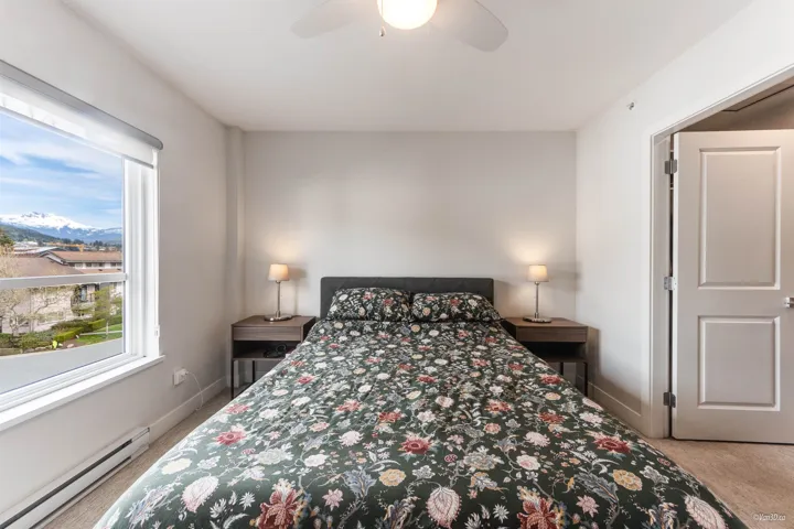 Bedroom with baseboard heating, carpet flooring, and a ceiling fan