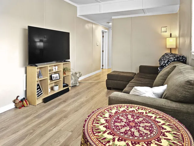 Living area featuring light wood finished floors and baseboards