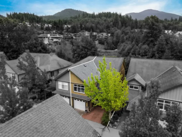 Two-story residence featuring composite roofing and horizontal siding with wood-finish accents