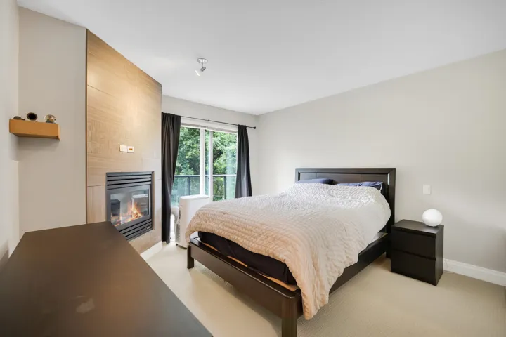 Integrated fireplace with a wood-finish accent wall and a floating wood shelf