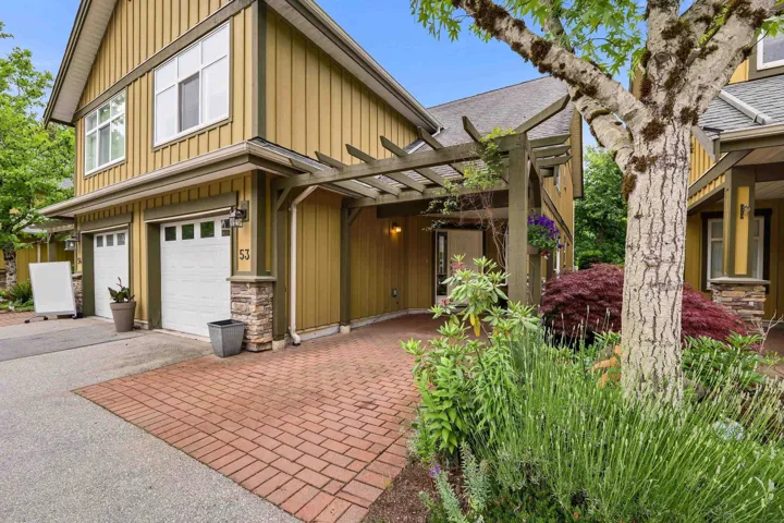 Two-story townhome with board and batten siding and stone accents