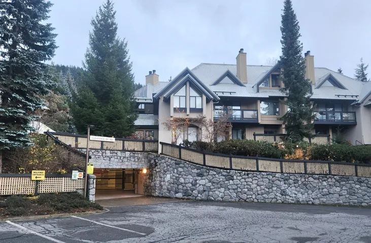 View of front of home with a chimney and stucco siding