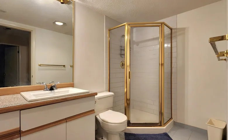 Full bathroom with a textured ceiling, a shower stall, vanity, and light tile patterned floors