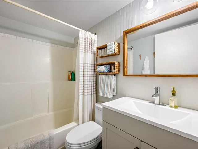 Bathroom with shower / bath combo and vanity