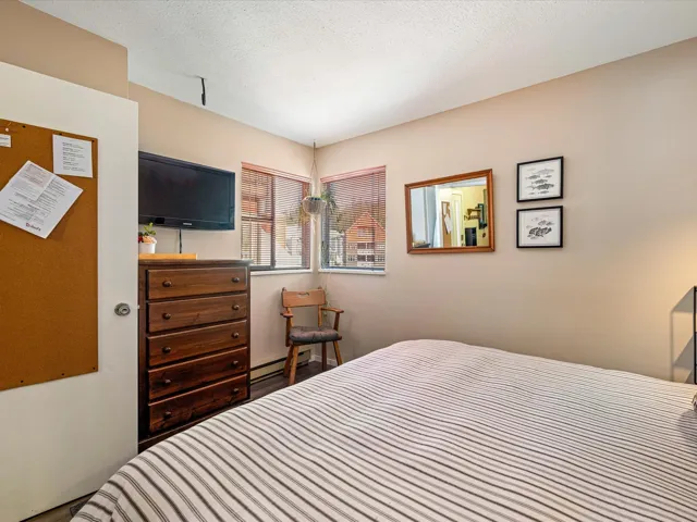 Bedroom featuring a textured ceiling and baseboard heating