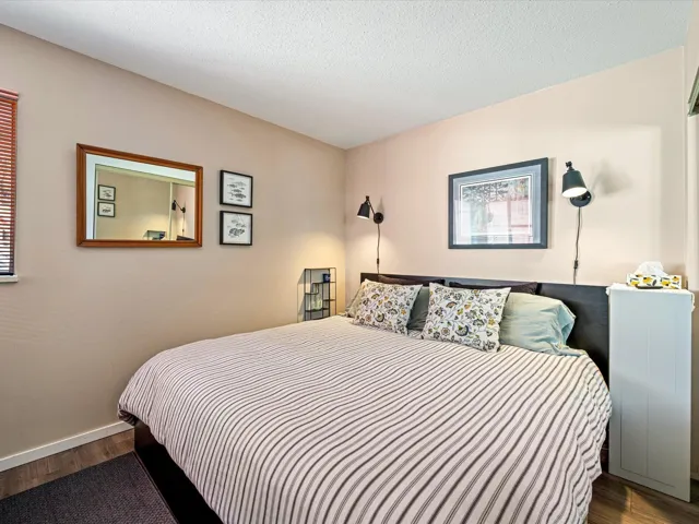 Bedroom featuring dark wood finished floors and a textured ceiling