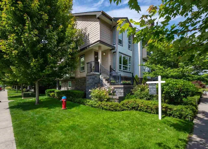 View of front facade with a front yard and stone siding