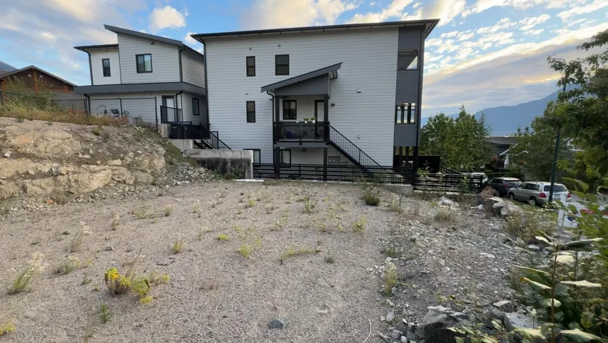 Back of house with stairway and a mountain view