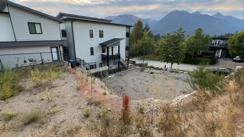 Back of property at dusk featuring a mountain view