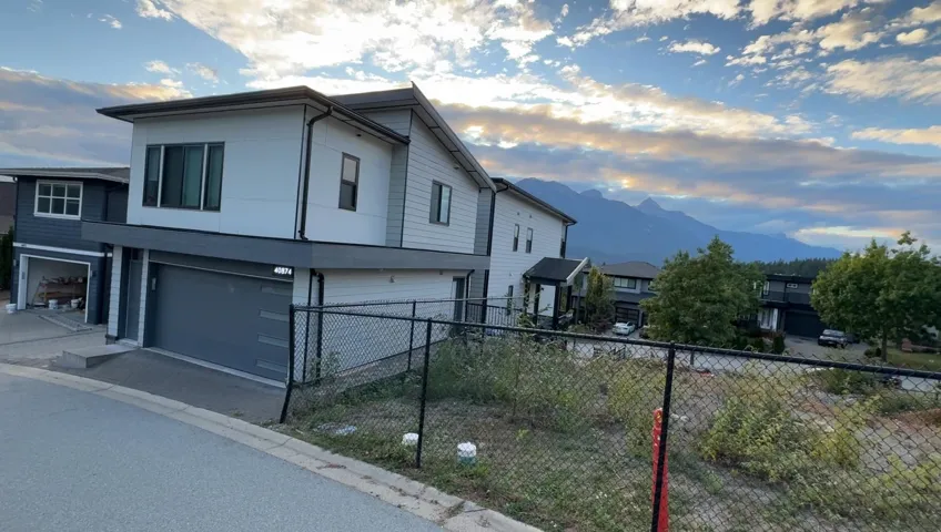 View of home's exterior with an attached garage and a mountain view