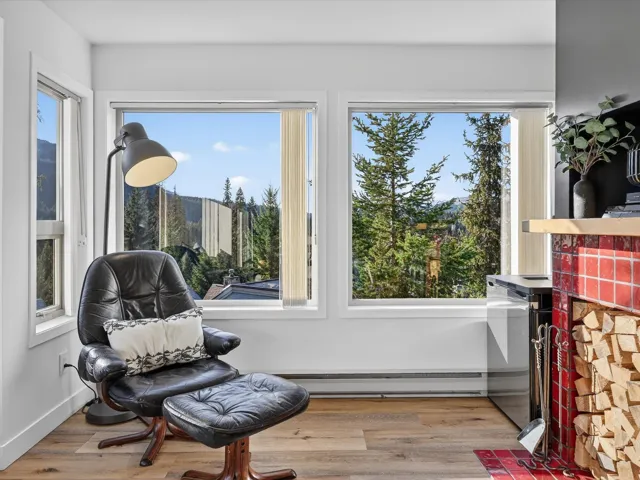 Living area with light wood finished floors and baseboard heating