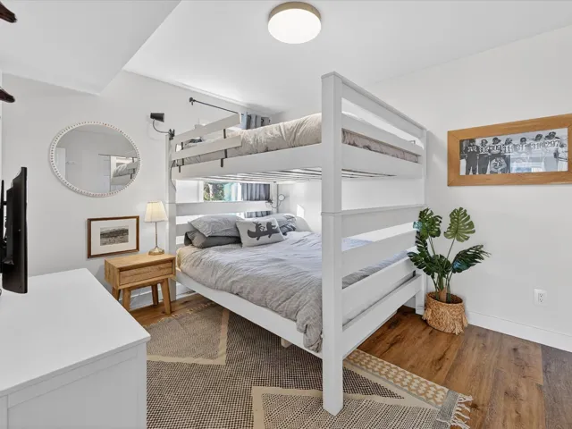 Bedroom with dark wood-style floors