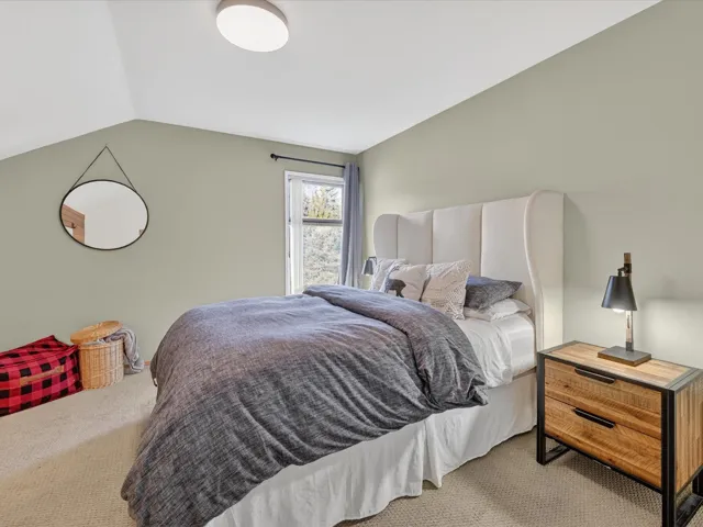 Carpeted bedroom with vaulted ceiling