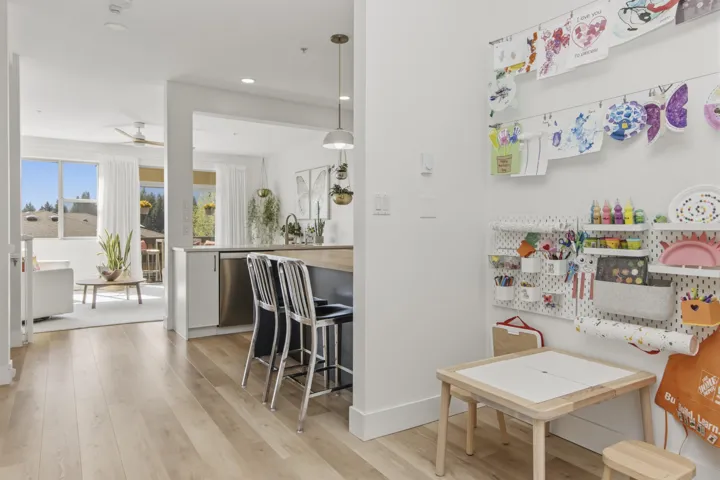 Open-concept room featuring light wood-finish flooring, recessed lighting, and white wall finishes