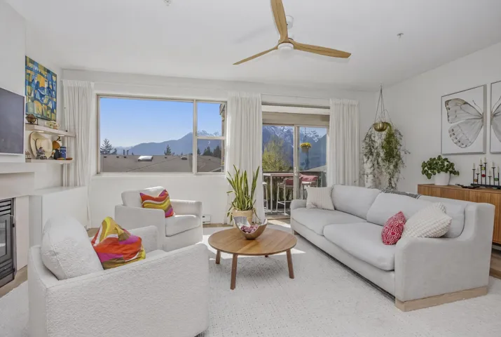 Recessed lighting illuminates the space, featuring light gray walls and a paneled white door