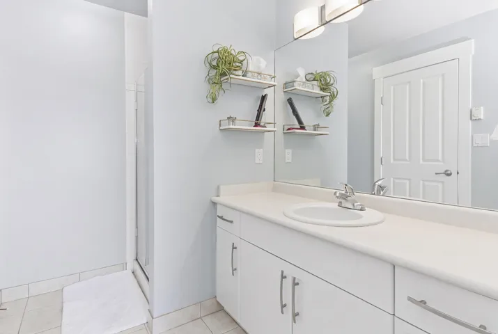 Carpeted room with recessed lighting, an office desk, and ample shelving for storage