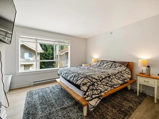 Bedroom featuring light wood-style flooring and baseboard heating