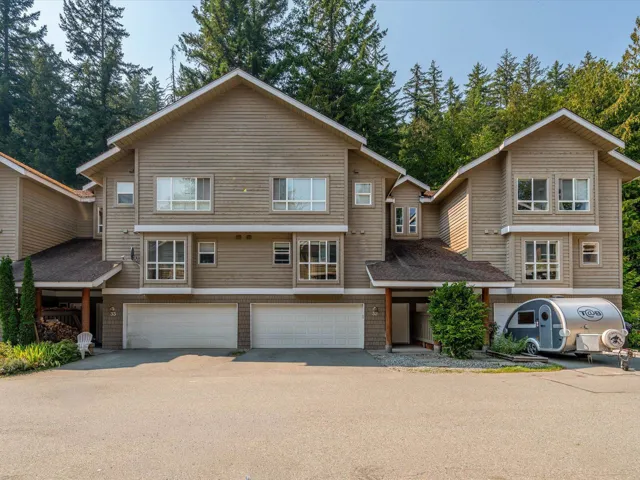 View of front of property with a garage and asphalt driveway