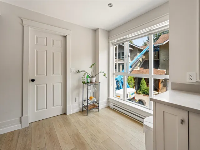 Dining area with a baseboard heating unit and light wood finished floors