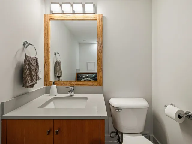 Half bathroom featuring vanity and toilet