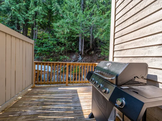 Wooden terrace featuring area for grilling
