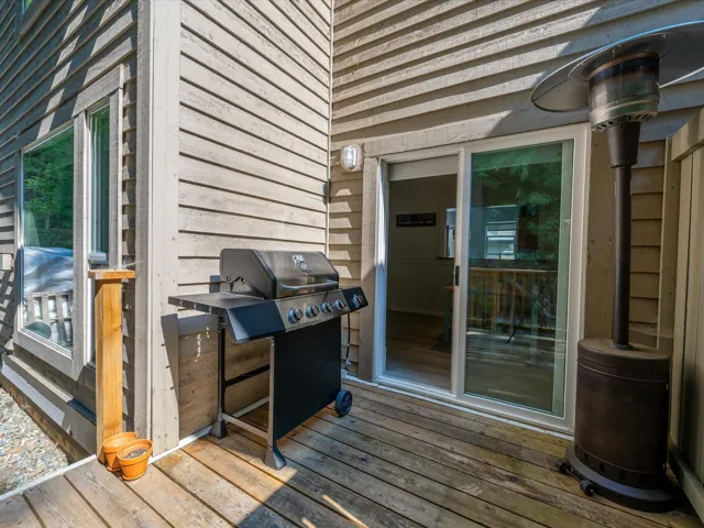 Wooden terrace featuring grilling area