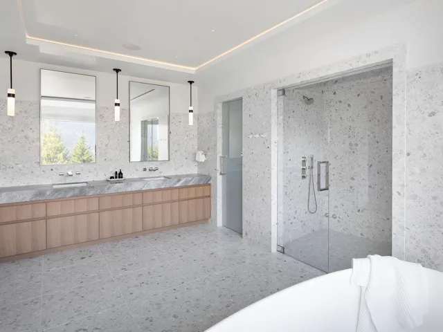 Bathroom with a stall shower, double vanity, and a tray ceiling
