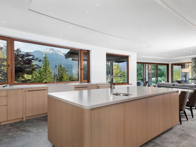 Kitchen featuring modern cabinets, light brown cabinetry, recessed lighting, a mountain view, and a center island with sink