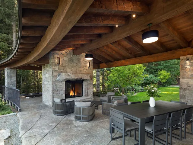 View of patio / terrace featuring an outdoor stone fireplace and outdoor dining area